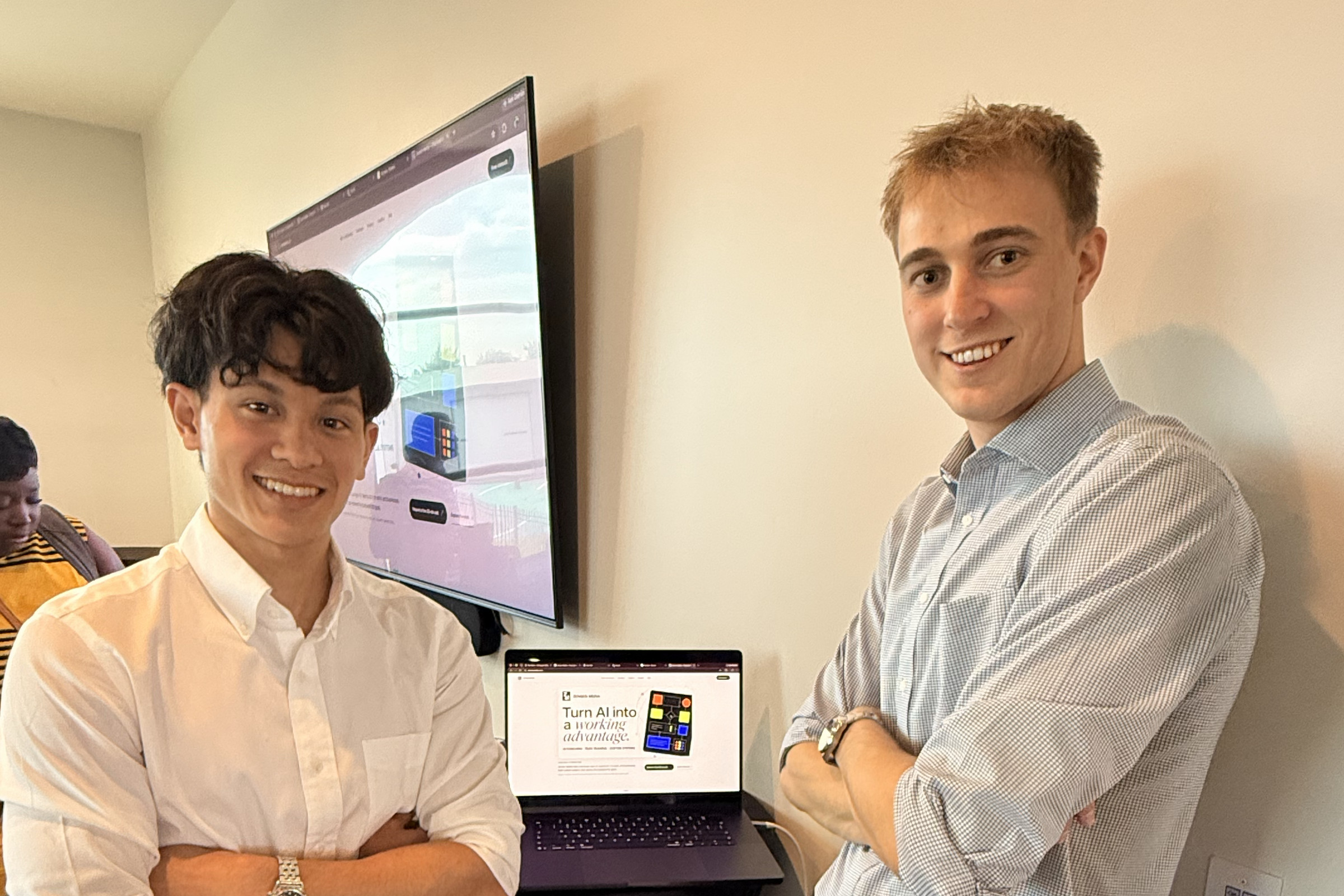 Thomas and another person beside a laptop at a Zensen workshop